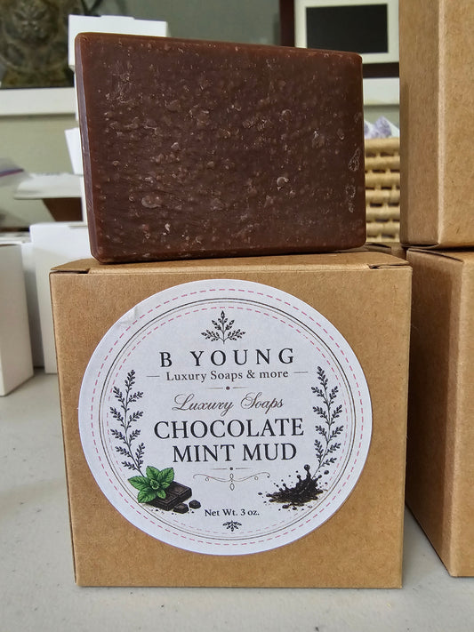 Brown Chocolate Mint Goat Milk Soap bar resting on its branded white box.